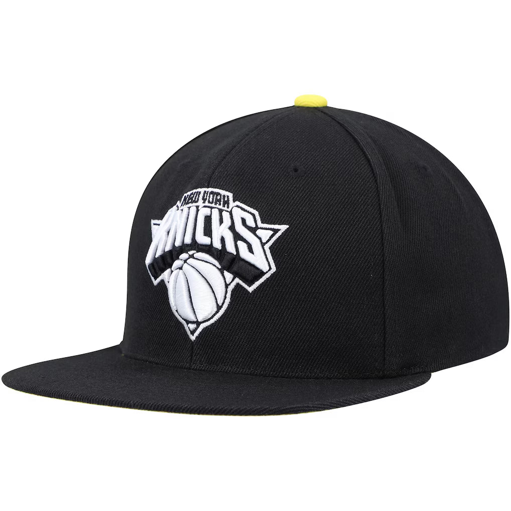 New York Knicks black and yellow snapback hat featuring a bold team logo and basketball design on the front.