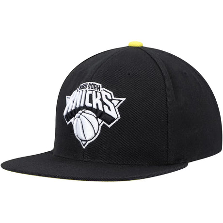 New York Knicks black and yellow snapback hat featuring a bold team logo and basketball design on the front.